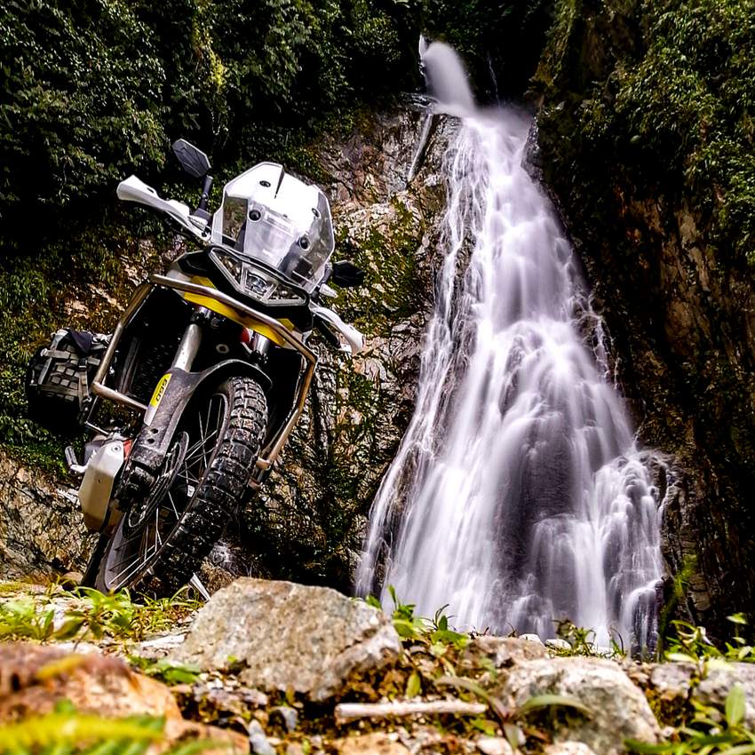 Aprilia Tuareg with waterfall in Ecuador