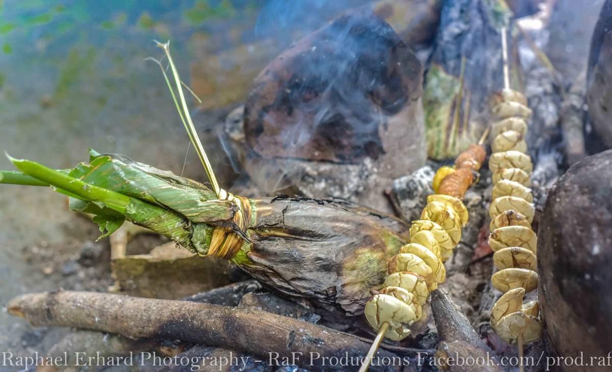 cooking over a fire in ecuador amazon basin on motorcycle adventure tour
