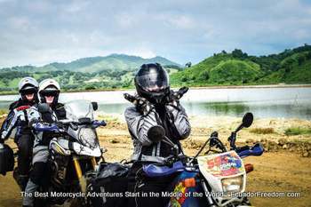 woman happy riding motorcycle in shrimp farm in ecuador