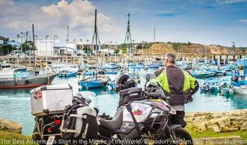 suzuki motorcycle and man looking at the port in manta ecuador