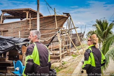 two motorcyclists looking at wood boat builders in manta ecuador