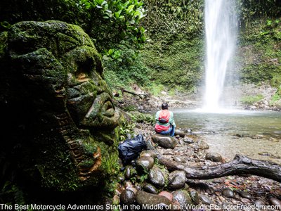 motorcyclist at hola vida waterfall in ecuador