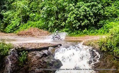 watercrossing over waterfall ecuador mashpi forest motorcycle adventure tour