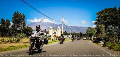 motorcycle riding with a church in the background on the Quilotoa Loop in Ecuador