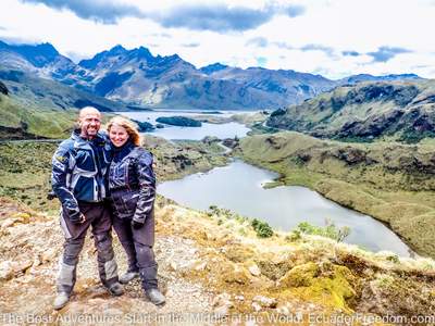 happy motorcyclists at high elevation lake in ecuador