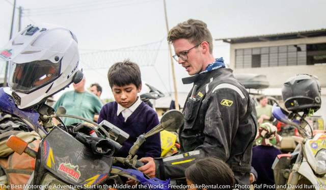 Andy Walcott Ecuador Freedom Motorcycle Guide interacting with children