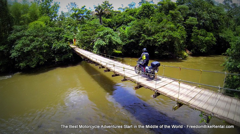 bridge_to_la_isla a suspension bridge with a motorcycle riding over it